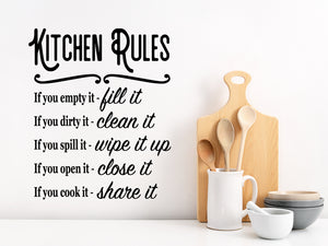 Wall decals for kitchen that say ‘Kitchen Rules’ in a script font on a kitchen wall.