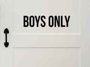 Wall decal for kids that says ‘Boys Only’ in a print font on a kid’s room wall. 