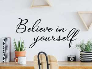 Decorative wall decal that says ‘Believe In Yourself’ on an office wall.