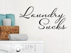 Laundry room wall decal that says ‘Laundry Sucks Script’ on a laundry room wall.