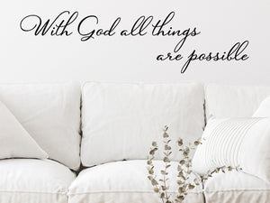 Living room wall decals that say ‘With God All Things Are Possible’ in a cursive font on a living room wall. 