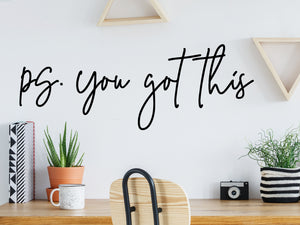 Decorative wall decal that says ‘PS You Got This’ on an office wall.