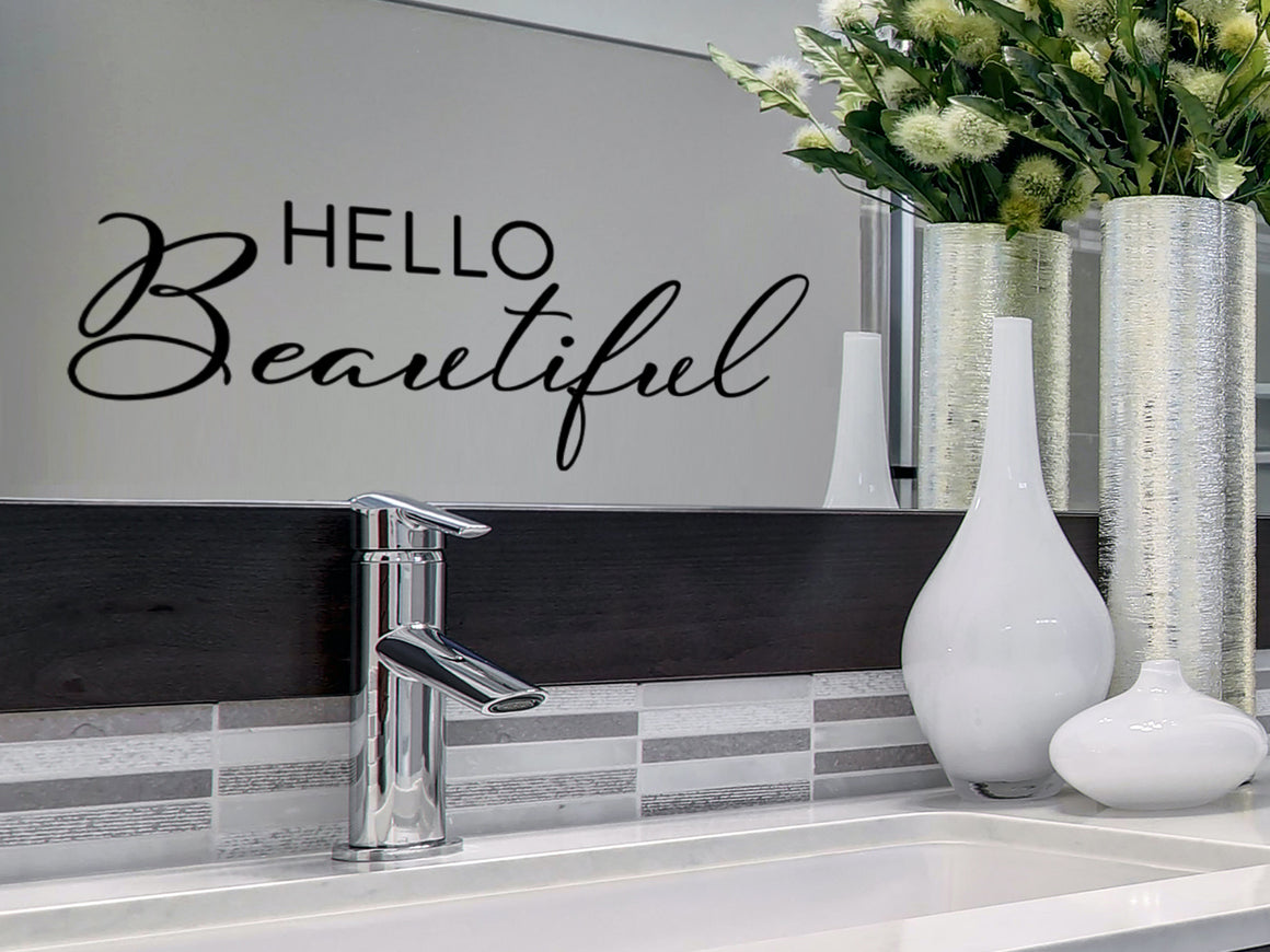 Wall decals for bathroom that say ‘Hello Beautiful’ in a cursive font on a bathroom wall.