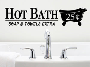 Wall decal for the bathroom that says 'Hot Bath Soap And Towels Extra 25 Cents' on a bathroom wall