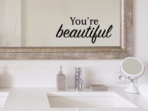 Wall decals for bathroom that say ‘You're Beautiful’ in a bold font on a bathroom mirror.