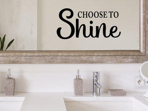 Wall decals for bathroom that say ‘Choose To Shine’ in a script font on a bathroom wall.