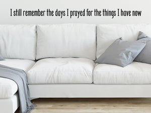 Living room wall decals that say ‘I still remember the days I prayed for the things I have now’ on a living room wall. 