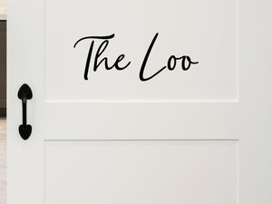 Wall decals for bathroom that say ‘The Loo’ in a script font on a bathroom wall.