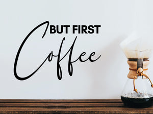 Wall decals for kitchen that say ‘But First Coffee’ in a cursive font on a kitchen wall.