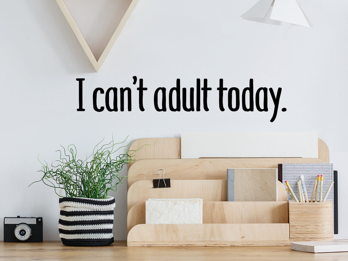 Decorative wall decal that says ‘I Can't Adult Today’ on an office wall.