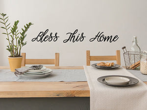 Wall decals for kitchen that say ‘Bless this home’ on a kitchen wall.