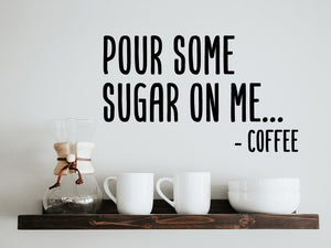 Decorative wall decal that says ‘Pour Some Sugar On Me... - Coffee’ on a kitchen wall.