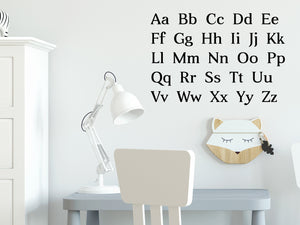 Decorative wall decal that has all the letters of the alphabet stacked into five rows on a kid’s room wall. 