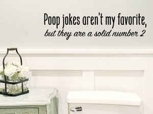 Wall decals for bathroom that say ‘Poop Jokes Aren't My Favorite But They Are A Solid #2’ on a bathroom wall.