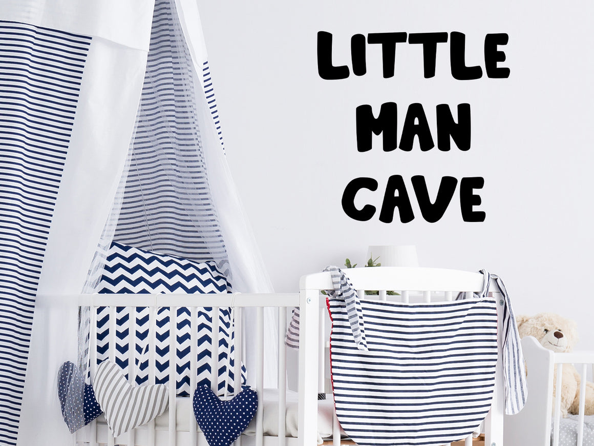 Wall decal for kids that says ‘Little man cave’ on a kid’s room wall. 