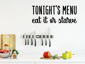 Decorative wall decal that says ‘Tonight's Menu Eat It Or Starve’ on a kitchen wall.