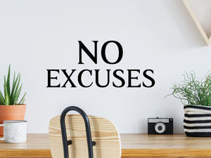 Decorative wall decal that says ‘No Excuses’ on an office wall.
