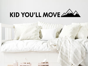 Wall decal for kids that says ‘Kid You'll Move Mountains’ on a kid’s room wall. 