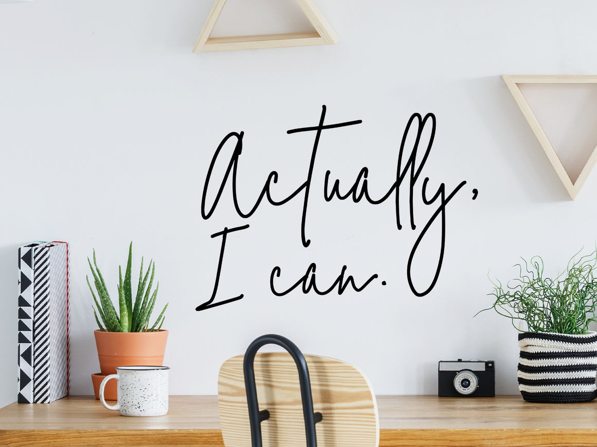 Decorative wall decal that says ‘Actually, I Can’ on an office wall.