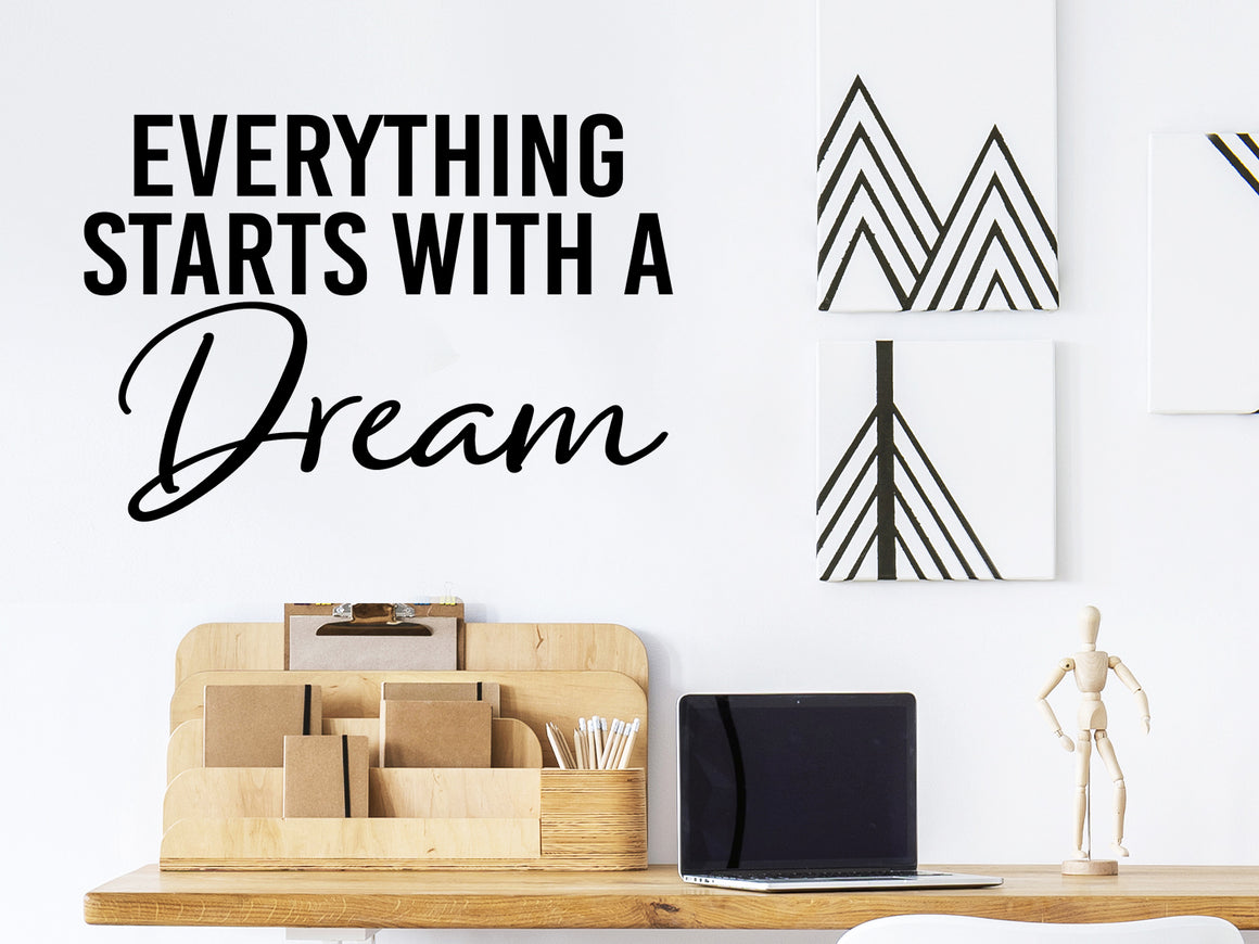 Wall decal for the office that says ‘Everything Starts With A Dream’ in a script font on an office wall.
