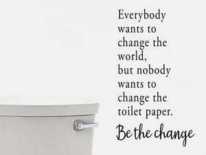 Wall decals for the bathroom that say ‘Everybody wants to change the word, but nobody wants to change the toilet paper. Be the change’ on a bathroom wall.
