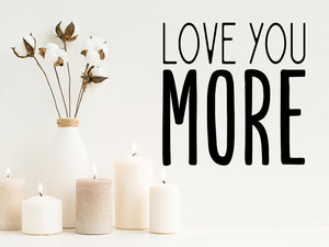 Wall decals for the bathroom that say, 'love you more' on a bathroom wall. 