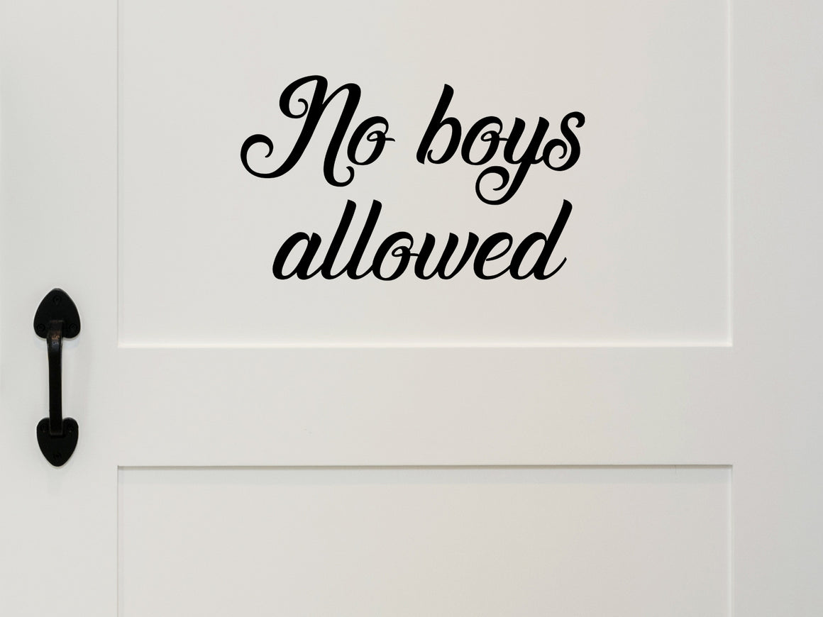 Wall decal for kids that says ‘No Boys Allowed’ in a cursive font on a kid’s room wall. 