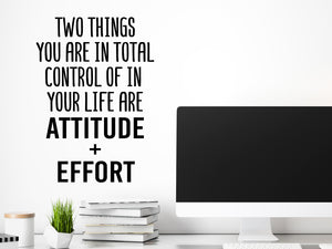 Decorative wall decal that says ‘Two Things You Are In Total Control Of In Your Life Are Attitude And Effort’ on an office wall.