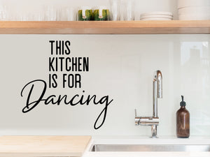 Wall decals for kitchen that say ‘This Kitchen Is For Dancing’ in a bold font on a kitchen wall.