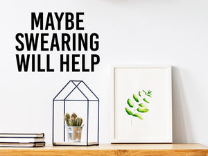 Wall decal for the office that says ‘Maybe Swearing Will Help’ in a bold font on an office wall.