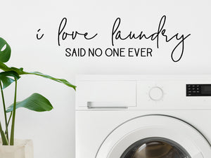 Laundry room wall decal that says ‘I Love Laundry (Said No One Ever)’ in a script font on a laundry room wall.
