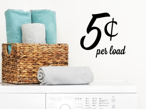Laundry room wall decal that says ‘5 Cents Per Load’ in a script font on a laundry room wall
