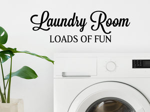 Laundry room wall decal that says ‘Laundry Room Loads Of Fun’ on a laundry room wall