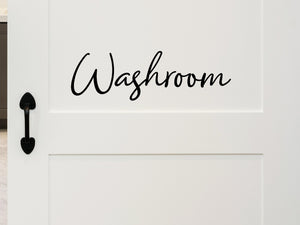 Wall decals for bathroom that say ‘Washroom’ in a cursive font on a bathroom wall.