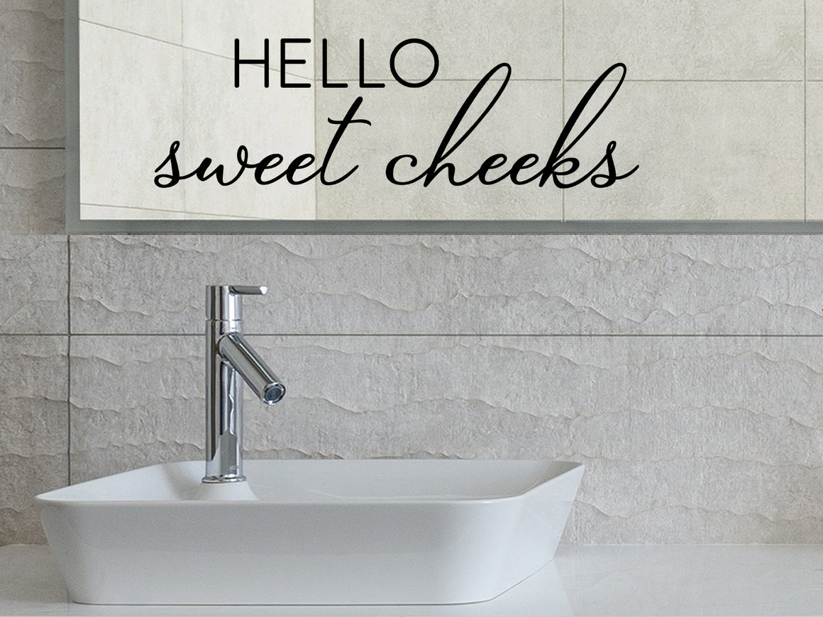 Wall decals for bathroom that say ‘Hello Sweet Cheeks’ in a script font on a bathroom wall.