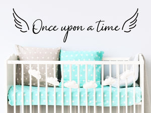 Wall decal for kids that says ‘Once Upon A Time’ in a cursive font on a kid’s room wall. 