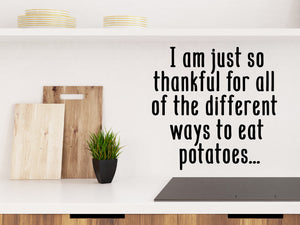 Decorative wall decal that says ‘I Am Just So Thankful For All Of The Different Ways To Eat Potatoes’ on a kitchen wall.