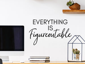 Wall decal for the office that says ‘Everything Is Figureoutable’ in a script font on an office wall.