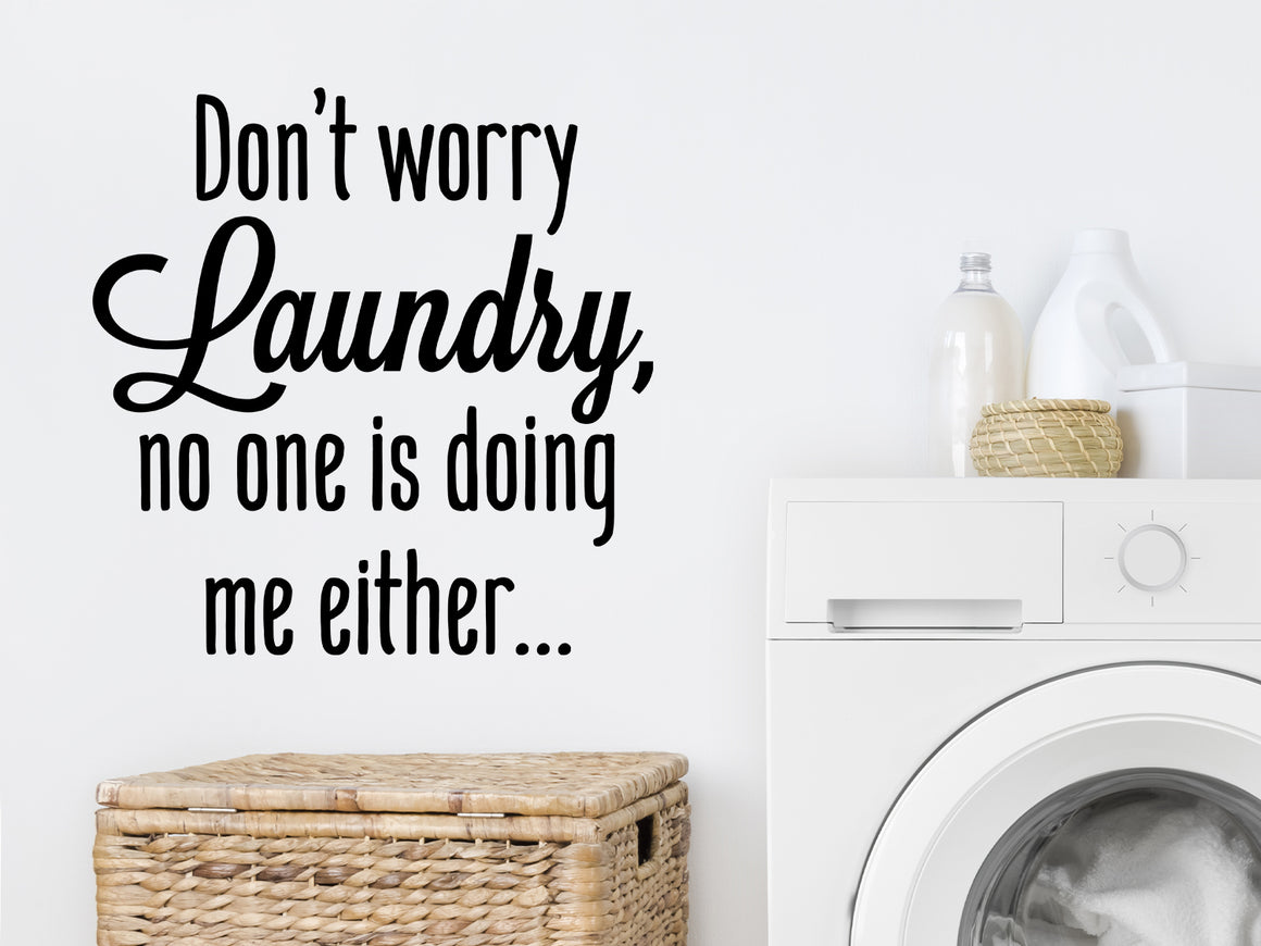 Laundry room wall decal that says ‘Don't Worry Laundry No One Is Doing Me Either’ on a laundry room wall.