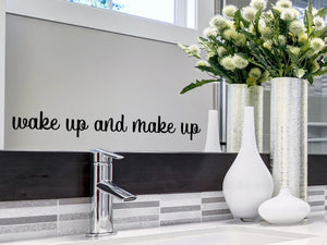 Bathroom mirror decal that say ‘wake up and make up’ on a bathroom mirror.