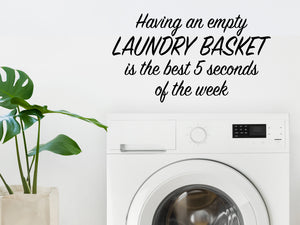 Laundry room wall decal that says ‘Having An Empty Laundry Basket Is The Best Five Seconds Of The Week’ in a script font on a laundry room wall