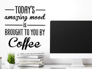 Decorative wall decal that says ‘Today's Amazing Mood Is Brought To You By Coffee’ on an office wall.