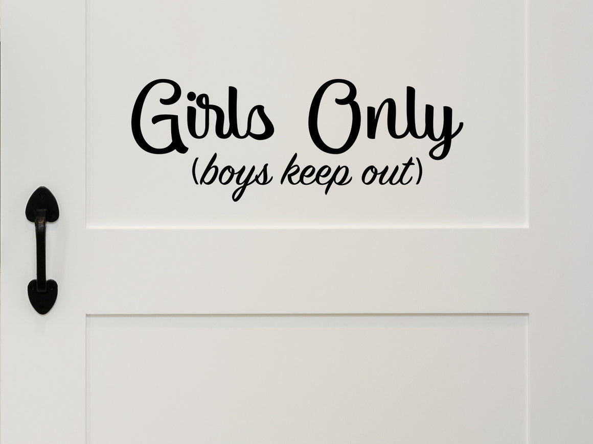 Wall decal for kids that says ‘Boys Keep Out Girls Only’ in a cursive font on a kid’s room wall.