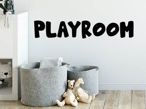 Wall decal for kids that says ‘Playroom’ in a print font on a kid’s room wall. 