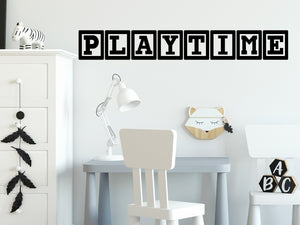 Wall decal for kids that says ‘Playtime’ in blocks on a kid’s room wall. 