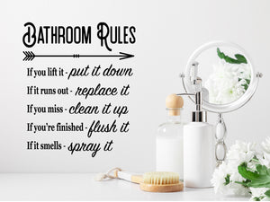 Wall decals for bathroom that say ‘Bathroom Rules If You Lift It Put It Down’ in a print font on a bathroom wall.