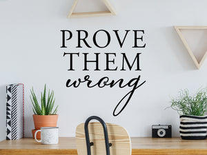 Decorative wall decal that says ‘Prove Them Wrong’ on an office wall.