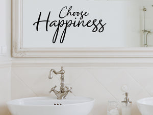 Wall decals for bathroom that say ‘Choose Happiness’ in a cursive font on a bathroom wall.
