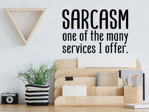 Decorative wall decal that says ‘Sarcasm One Of The Many Services I Offer’ on an office wall.