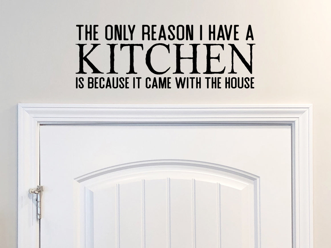 Wall decals for kitchen that say ‘The Only Reason I Have A Kitchen Is Because It Came With The House’ on a kitchen wall.